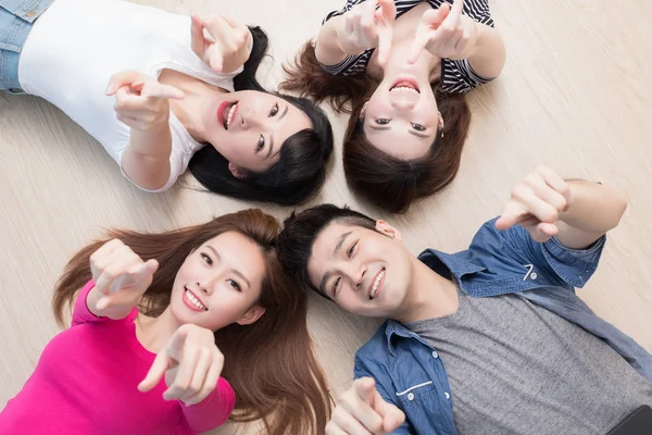People  lying on floor and pointing — Stock Photo, Image