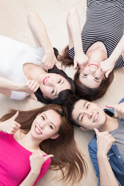 Young people showing thumbs up — Stock Photo, Image