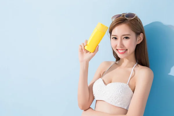 Женщина держит солнцезащитный крем — стоковое фото