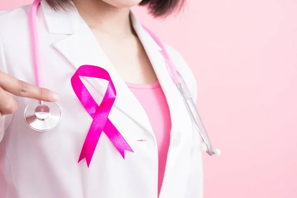 Woman doctor pointing pink ribbon — Stock Photo, Image
