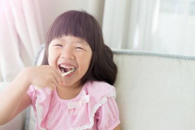 small girl brushing teeth clipart