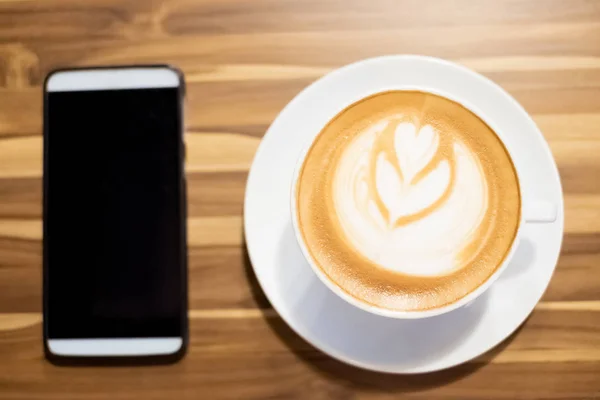 Coffee and smartphone on table — Stock Photo, Image