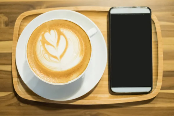 Coffee and smartphone on table — Stock Photo, Image