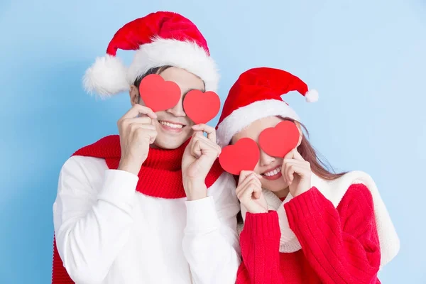 Couple covering eyes with hearts — Stock Photo, Image