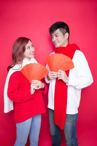 Couple holding red envelopes — Stock Photo, Image