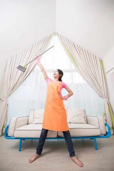 Woman with mop  in the living room — Stock Photo, Image