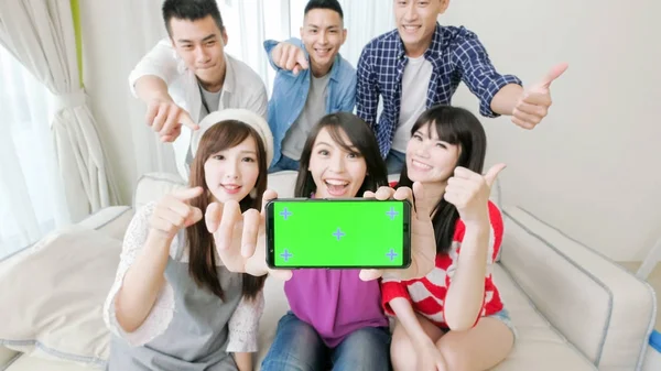 young people showing screen to you and smiling  happily, focus on phone