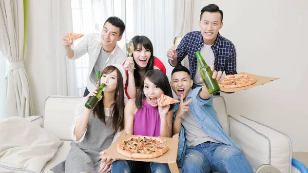 young people eating  pizza and drinking  beer on  party