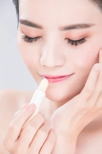 Woman Using Lip Balm Gray Background — Stock Photo, Image