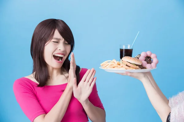 Frau Verweigert Ungesundes Essen Auf Blauem Hintergrund — Stockfoto