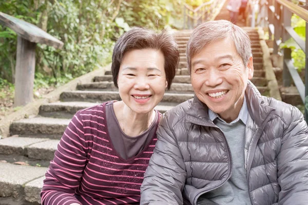 old couple smiling  happily in the park