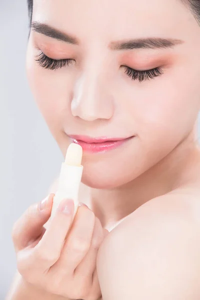 Woman Use Lip Balm Gray Background — Stock Photo, Image