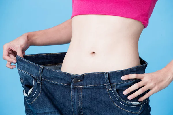 Woman Wearing Oversize Jeans Showing Weight Loss Blue Background — Stock Photo, Image