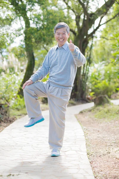 old man with healthy  knee  showing thumb up