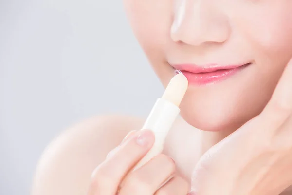 Woman Using Lip Balm Gray Background — Stock Photo, Image