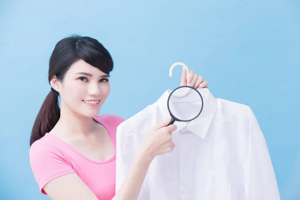 Woman Holding Clean Shirt Magnifying Glass Blue Background — Stock Photo, Image