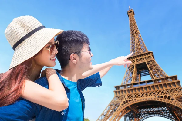 couple in paris  pointing at  Eiffel tower
