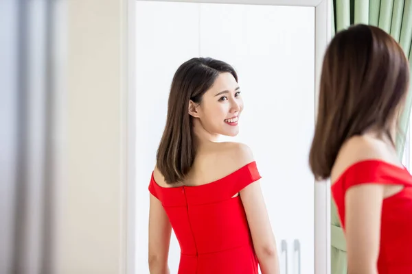 Asian girl trying dress happily — Stock Photo, Image