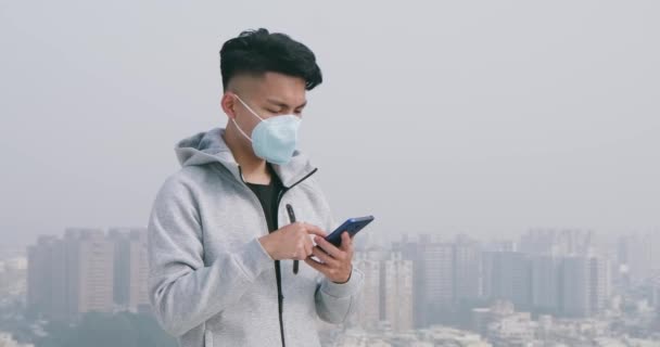 Man gebruik smartphone met masker — Stockvideo