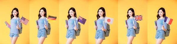 happy asian college student girl hold different national flags in front of yellow background