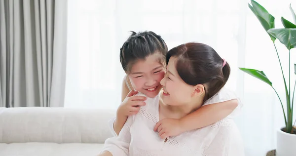 asian daughter girl whisper to mother and they smile