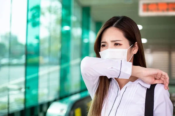 亚洲妇女手肘咳嗽 戴口罩 她在地铁站或火车站上下班 — 图库照片