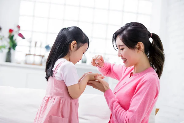 Mom teach child wash hands with sanitizer alcohol gel to avoid covid-19 at home