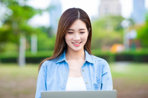 Smart asian young girl student study something during internet online courses and she search information via laptop computer outdoors