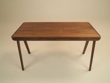 Beautiful wooden table with four legs. Shot in a Studio on a white background.