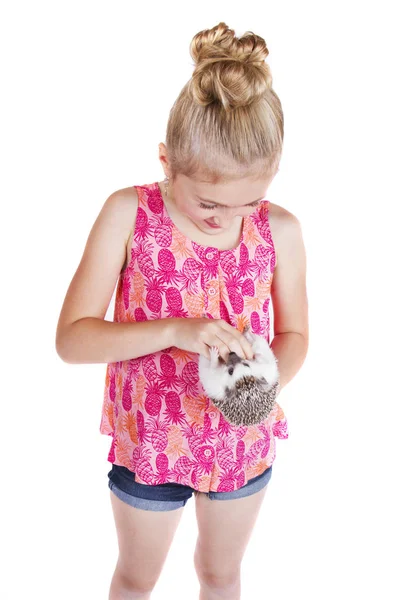 A young girl petting the stomach of her pet hedgehog — Stock Photo, Image