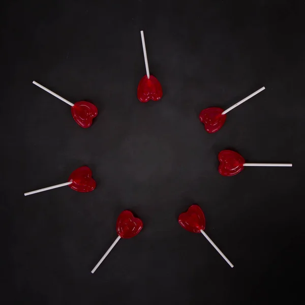 Heart shaped lollipops on a chalkboard — 스톡 사진