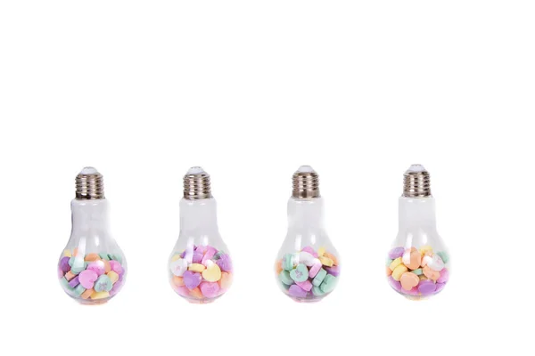 Conversation hearts in a light bulb container — Stock Photo, Image