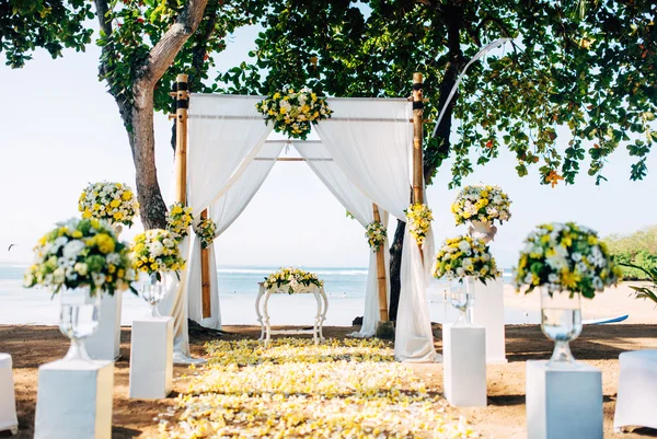 Wedding preparation, setting details. Romantic ceremony on beach with ocean background