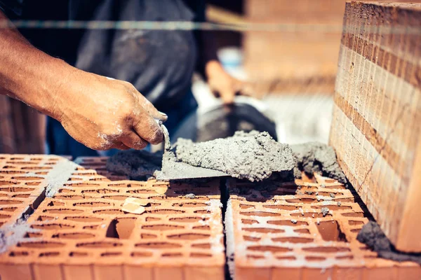 Close up details of industrial bricklayer installing bricks on construction sit — Stock Photo, Image