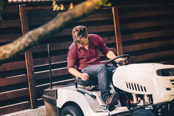 Professional gardner riding lawn mower - landscaping and gardening details — Stock Photo, Image