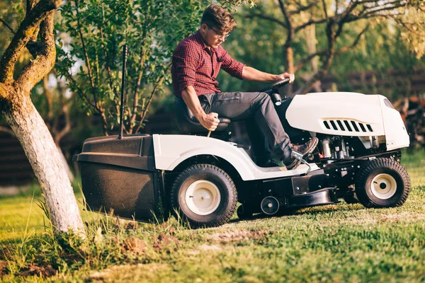 Ev bahçe çim kesme için çim biçme makinesi kullanarak profesyonel erkek peyzaj mimarı — Stok fotoğraf