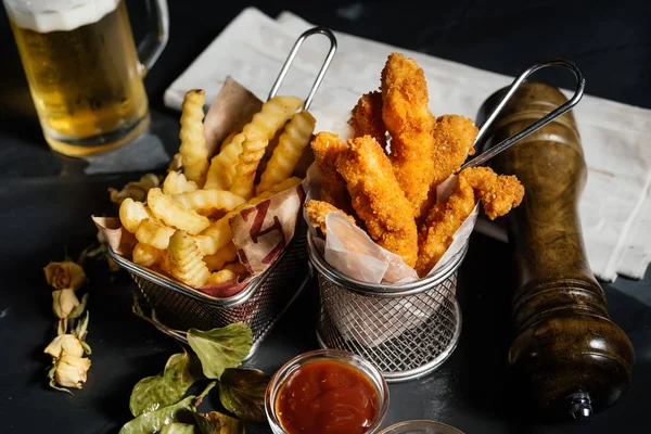 delicious fried chicken fingers with french fries and ketchup served at restaurant