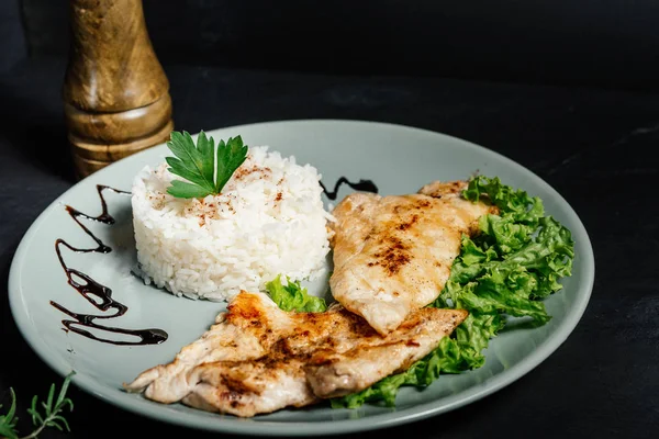 Grilled chicken breast with risotto and parsley served at bistro — Stock Photo, Image