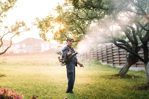 Industrial agricultural details - farmer working, spraying pesticides in fruit orchard — Stock Photo, Image