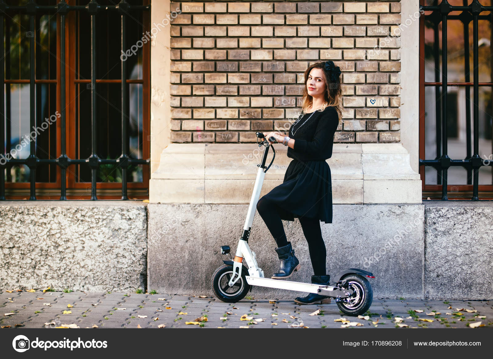 Trendy carefree woman on kick scooter in urban landscape ⬇ Stock Photo ...