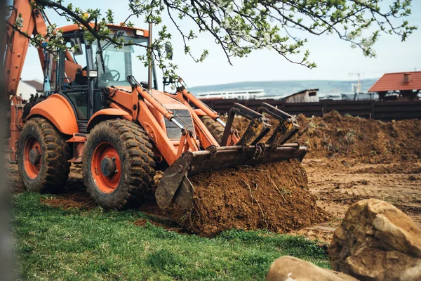 heavy duty earth moving bulldozer doing landscaping works and moving soil