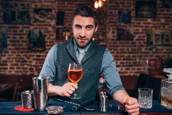 Expert bartender presenting Signature drink at local pub, bar or restaurant — Stock Photo, Image