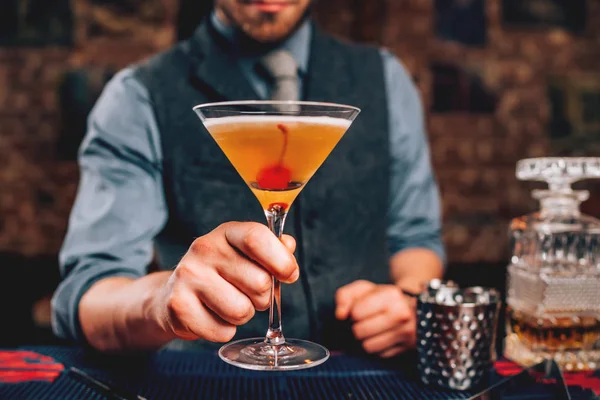 Barman que serve coquetel manhattan em vidro martini — Fotografia de Stock