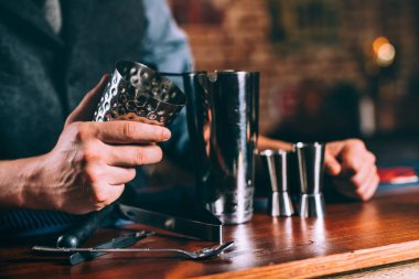Detayları barmen el kokteyl araçlarını kullanarak kapatın. Profesyonel barmen çalışan bar