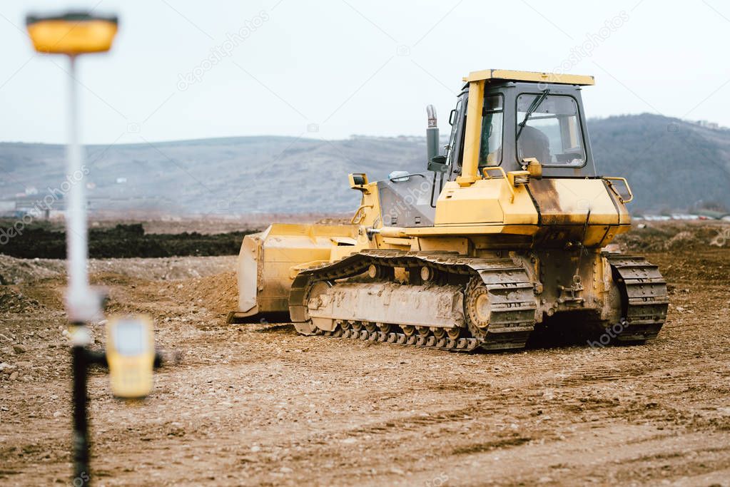 highway and road construction site with motor grader, excavator and bulldozer working 