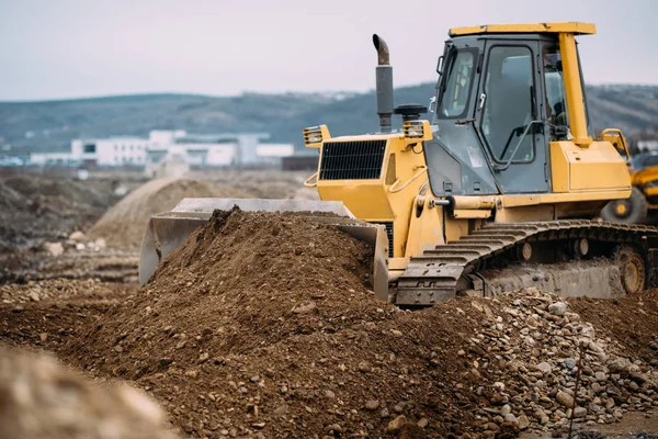 Industrial heavy duty machinery, details of excavator pushing earth and building highway. construction site