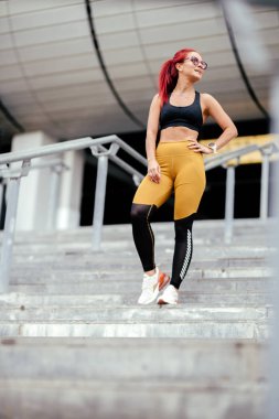 Stadyumda vücut egzersizi, sağlıklı bir kadın spor yapıyor. Merdivenlerde koşan kadın.