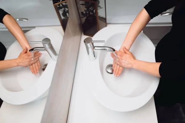 世界中のコロナウイルス流行時に美しい妊婦が手を洗う — ストック写真