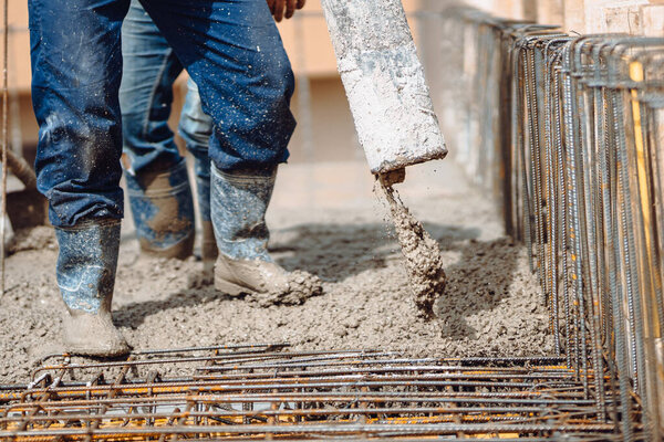 close-up details of house building details - Worker pouring concrete into house beams