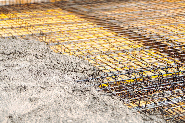 construction site details - concrete pouring in slabs. Cement and concrete over reinforced stee
